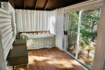 Day bed located in the sun room with curtains